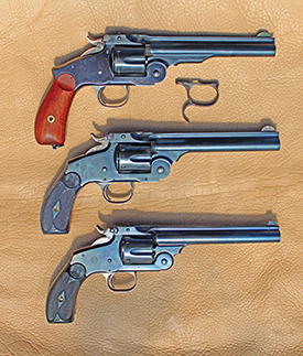 S&W Model 3 Top-Break Revolvers. The top is a Uberti replica of the Third Model Russian, the immediate predecessor of New Model No.3 (also, with the spur trigger-guard common to the Russian), the middle is Uberti replica of New Model No. 3 “Frontier” (weighing 43 ounces), the bottom is original Smith and Wesson New Model No. 3 (weighing 39 ounces) in 44 Russian, manufactured in 1898.